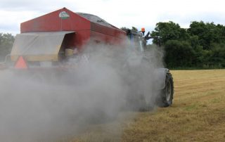 Tractor spreading agri lime in field