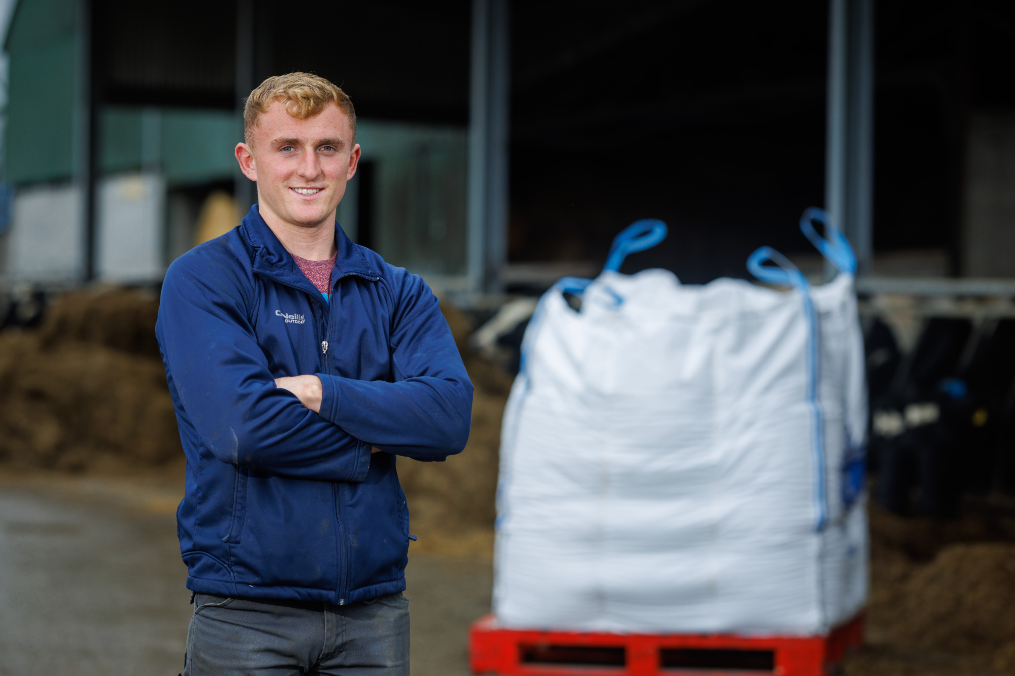 Farmer standing in shed