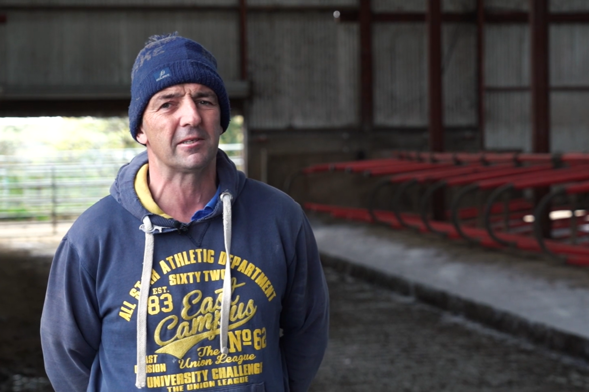 Farmer standing in shed