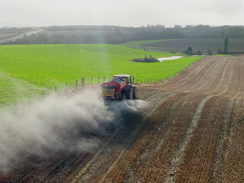overhead shot of tractor spreading hi-calcium agricultural lime